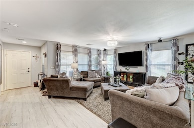 Living room featuring plenty of natural light and light wood-type flooring
