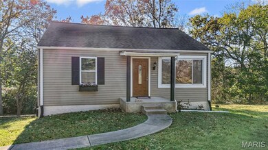 View of front of property featuring a front yard and a shingled roof
