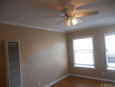 Living room with two large windows and wall heater
