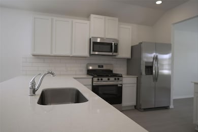 Kitchen with stainless steel appliances, backspla