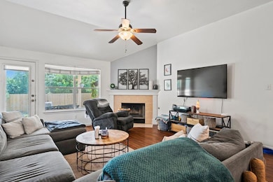 Living area featuring lofted ceiling, wood finish