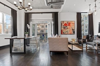 Dining area featuring a notable chandelier, baseboards, and dark wood finished floors
