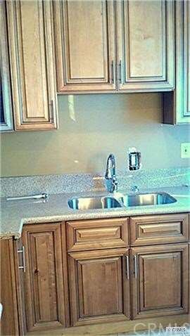 Granite, faucet, new cupboards travertine floor