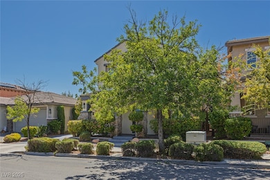 View of property hidden behind natural elements featuring stone siding and stucco siding