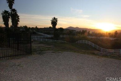 View from the driveway area of the backyard and be