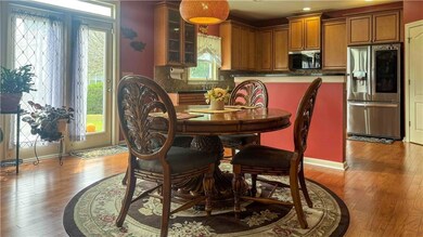 Dining space with light wood-style floors and baseboards