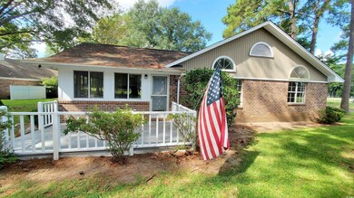 Rear view of property with a yard and a deck