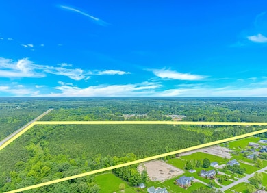 Aerial view of property and surrounding area with 