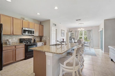 The open layout connects the kitchen, living, and dining areas, offering a seamless flow for entertaining and daily life.