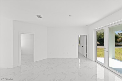 Empty room with light marble finish floors and fre