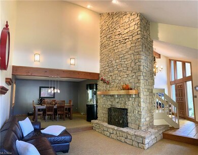 Open Vaulted living room with 2 story stone firepl