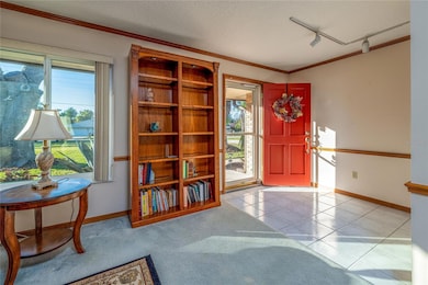 A storm door allows plenty of light to come through the front of the home.