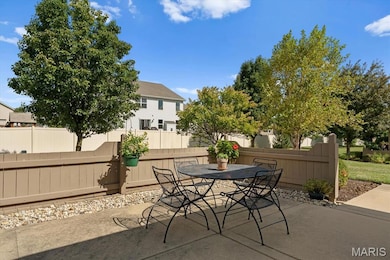 Fenced backyard with outdoor dining space and a patio area