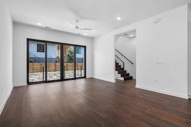 Unfurnished room with stairs, ceiling fan, dark w