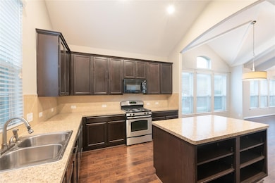 Kitchen featuring black microwave, stainless stee