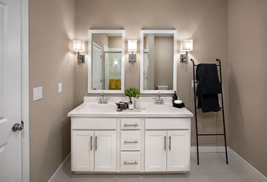 Primary bath with dual white-framed mirrors
