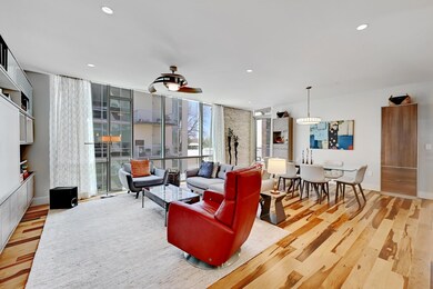 Living room featuring wood finished floors, a wal