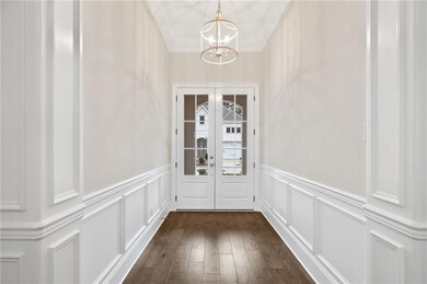 Impressive front entrance Foyer is an example of t
