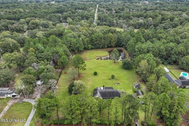 Aerial of the home, land, and pond