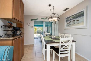 Dining room with light tile patterned flooring and a chandelier