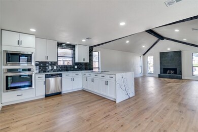 Kitchen featuring light wood-type flooring, stainl
