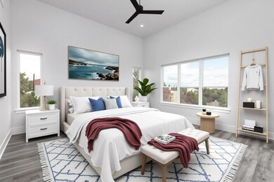 Bedroom with multiple windows, wood finished floo
