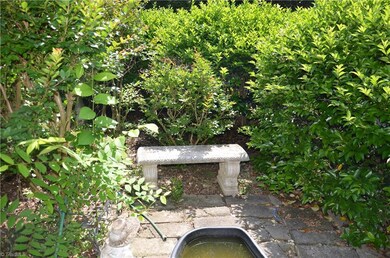 The secret garden includes an archway entrance, and goldfish pond.
