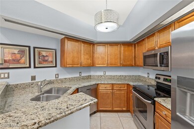 Kitchen with brown cabinetry, stainless steel appl