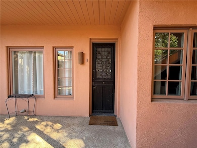 Entrance to property with stucco siding