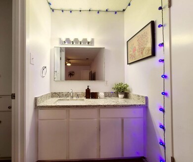 Bathroom featuring ceiling fan and vanity
