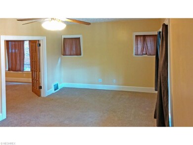 Another beveled glass door leads to this large liv