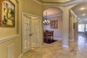 Open concept, crown molding, arch detailed opening