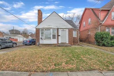Bungalow-style house with a front lawn, a chimney, and brick siding