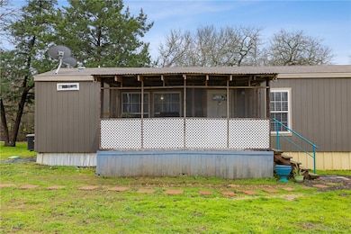 Rear view of property with a lawn