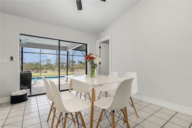 Dining room with a ceiling fan and light tile patt