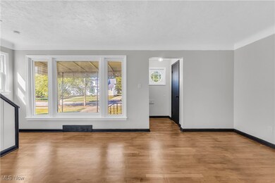 Spare room featuring a textured ceiling and wood finished floors