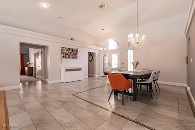 Dining room featuring a chandelier, lofted ceiling