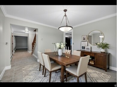 Virtually Staged Dining room featuring ornamental molding and stairway