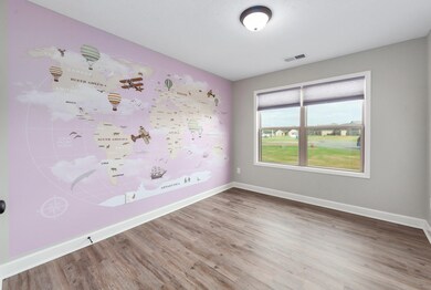 Spare room featuring wood finished floors, baseboa