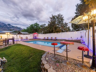 View of pool with a patio, a fenced backyard, and a mountain view