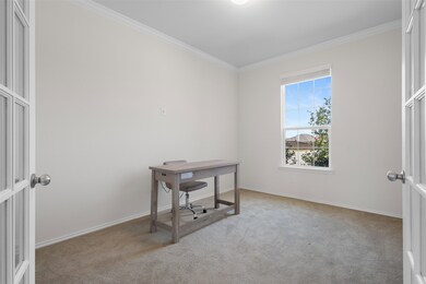 Traditional-style house featuring concrete driveway, brick siding, and a garage