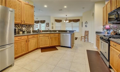 Large kitchen with custom backsplash and 42