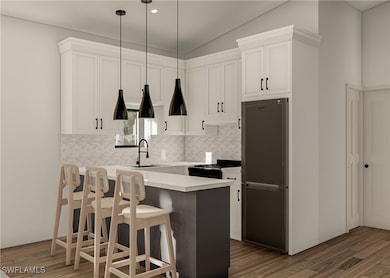 Kitchen featuring wood finished floors, gas stove,