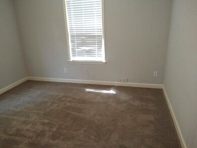 Unfurnished room featuring dark colored carpet