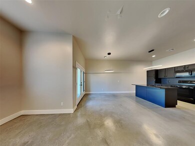 Kitchen featuring stove, pendant lighting, and a kitchen island