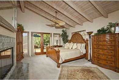 Generous master bedroom with french doors leading 