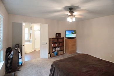 Bedroom featuring carpet flooring, ensuite bath, a