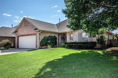 View of front of home with a front lawn and a gara