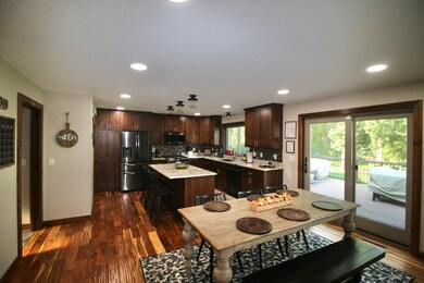 Open kitchen to dining area with a new patio door leading to the backyard deck..jpg