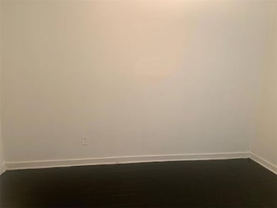 Empty room featuring baseboards
